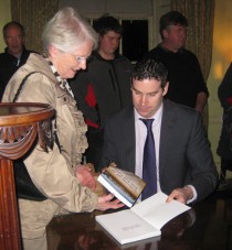 Author Ciarán Reilly signing a copy at the book launch 